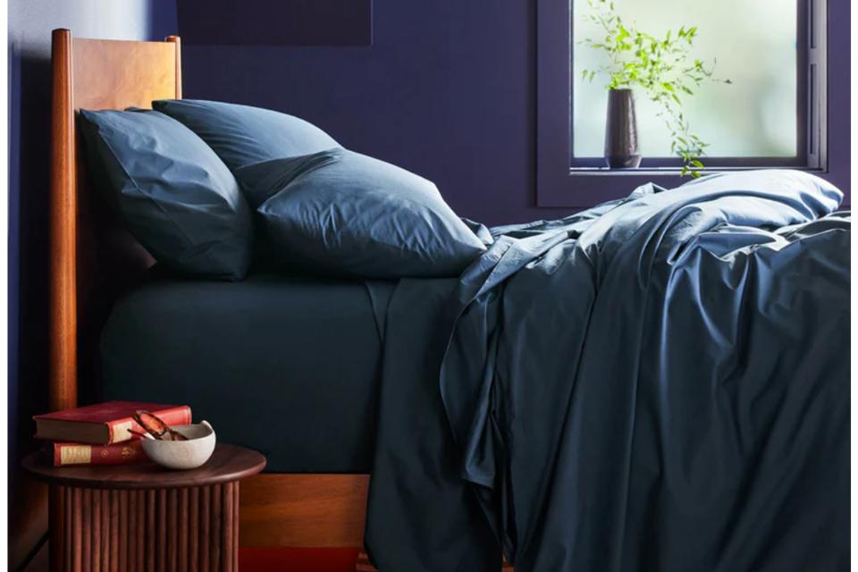 photo of Brooklinen Classic Percale Core Sheet Set in abyss (dark blue) in bedroom