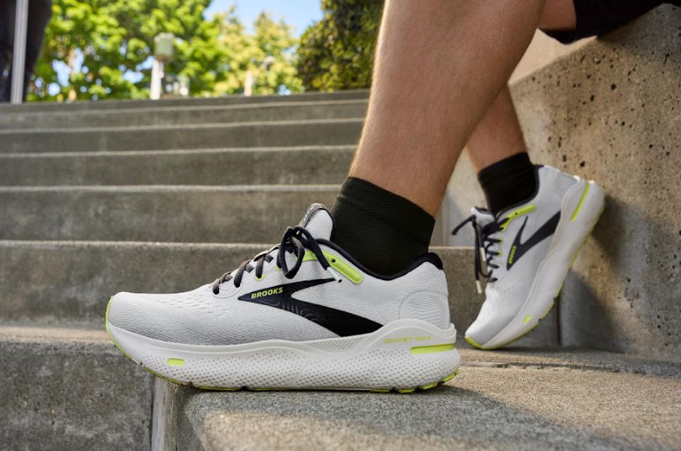 A person wearing the Brooks Ghost Max running shoes on concrete steps