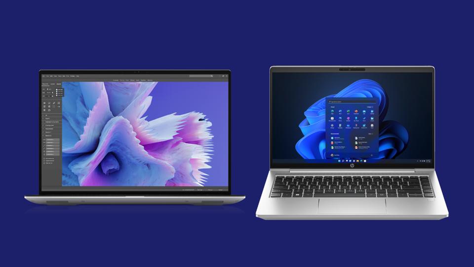 Two business laptops on a dark blue background