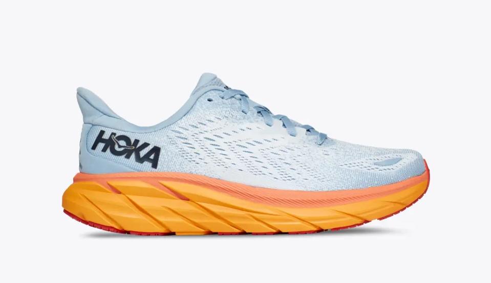 A blue and orange Hoka Clifton 8 sneaker against a white background.