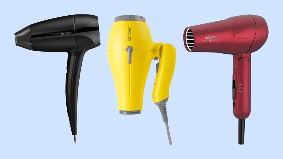 Three travel hair dryers against light blue background