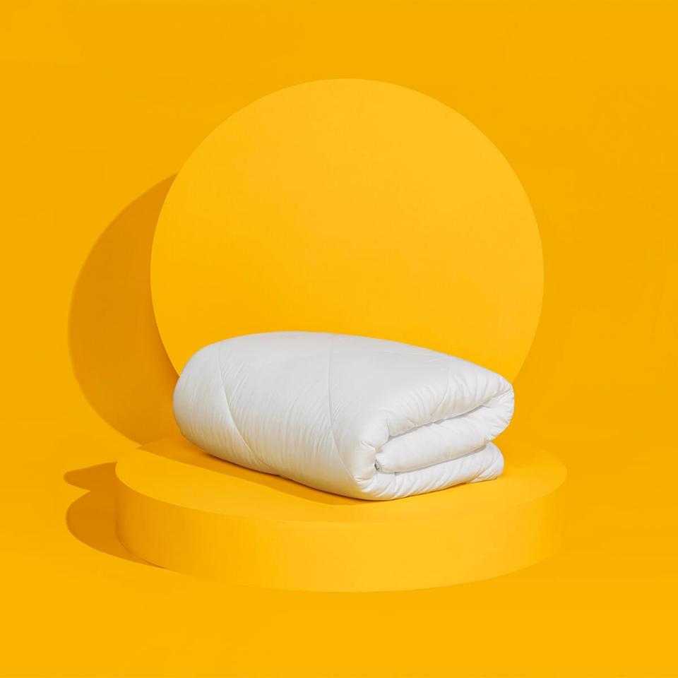 The UltraCool Comforter on a yellow background. 