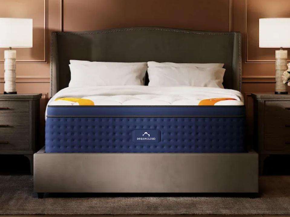 The DreamCloud Premier Rest in a bedroom in between two nightstands and lamps