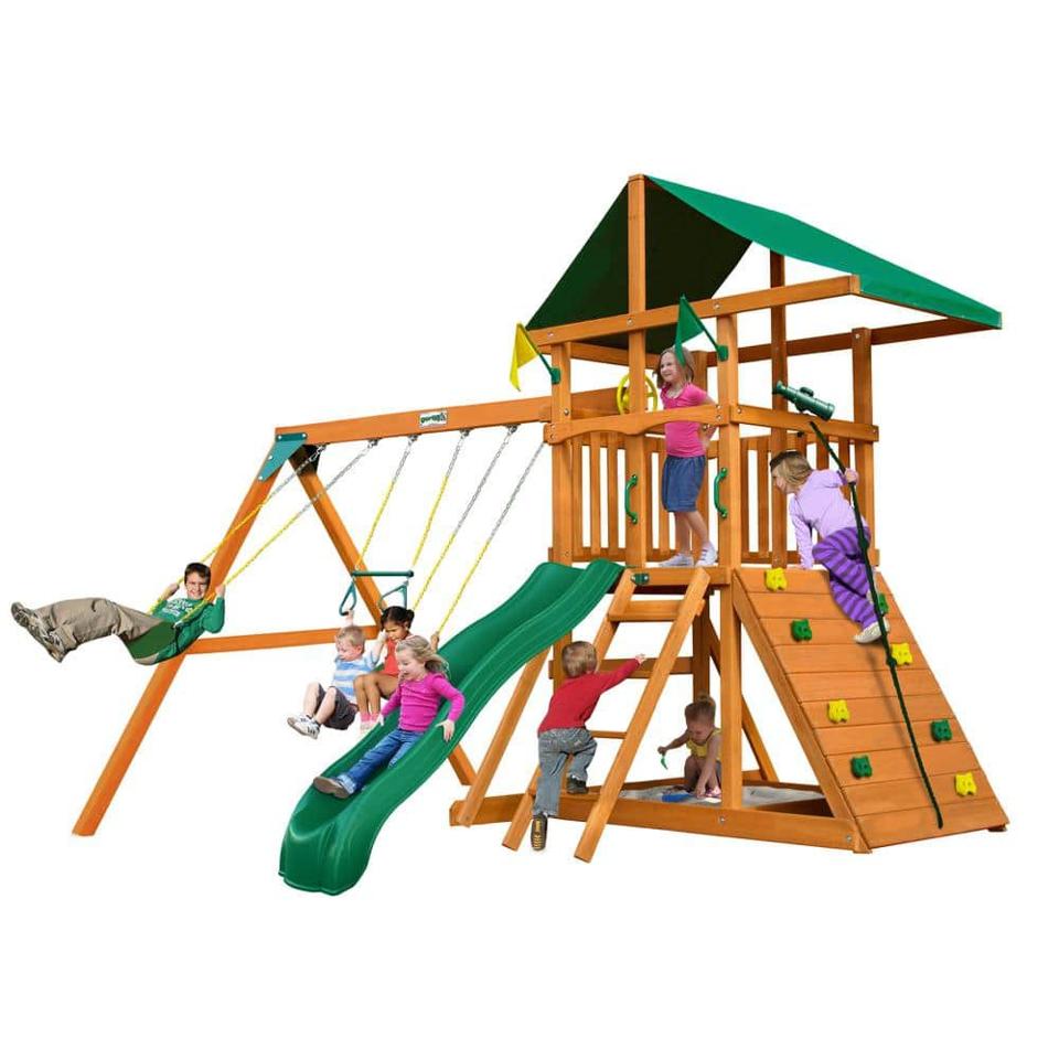 Kids playing on the Gorilla Playsets DYI Outing III Wooden Outdoor Playset with Tarp Roof