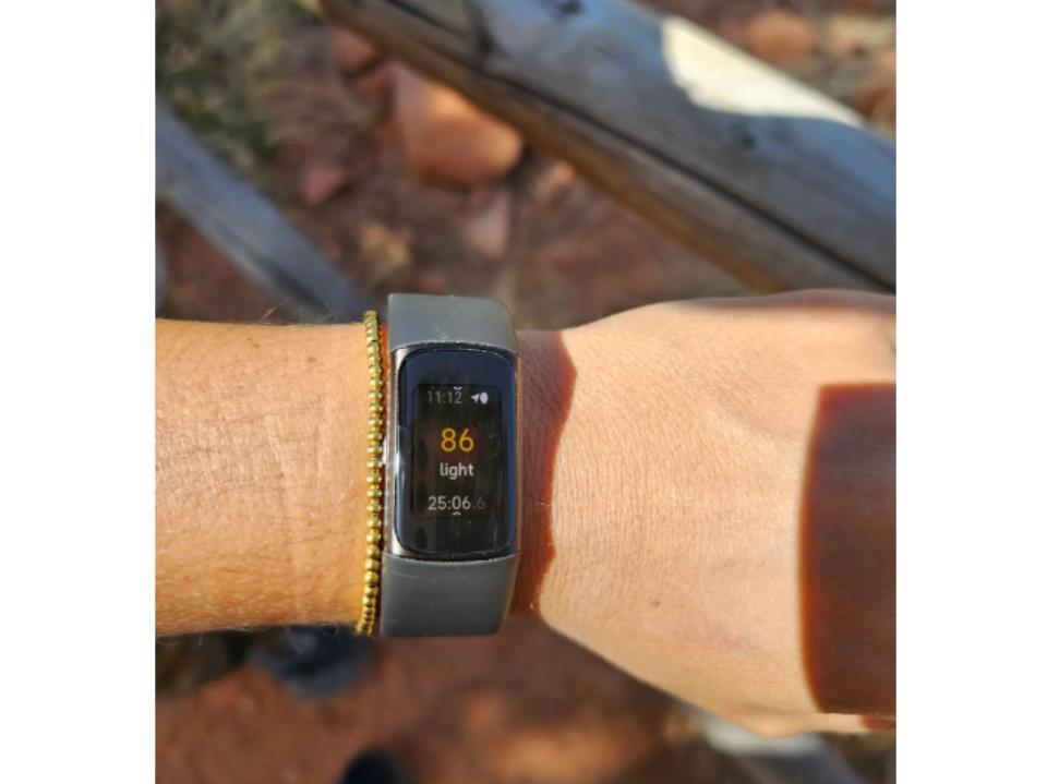 Fitbit Charge 6 Fitness Tracker on left wrist of forbes vetted staffer outside