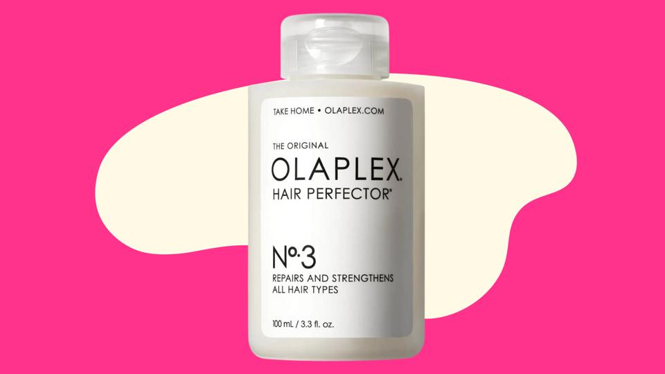 A bottle of Olaplex No. 3 Hair Perfector on a pink abstract background