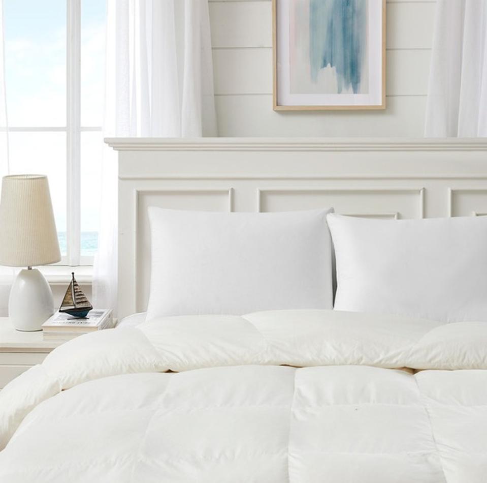 Two 3-in-1 Adjustable RDS 600 Fill Power White Goose Down Pillows shown on a bed.