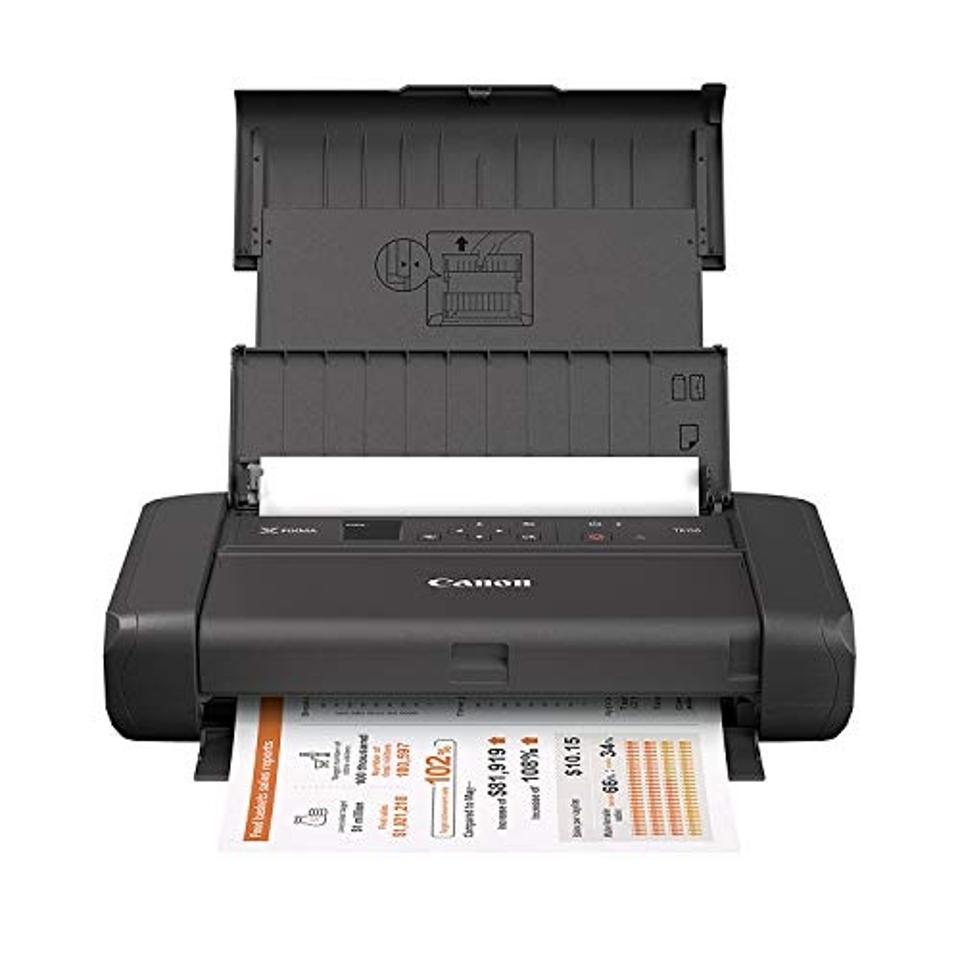 The Canon Pixma TR150 printing out a color page on a white background