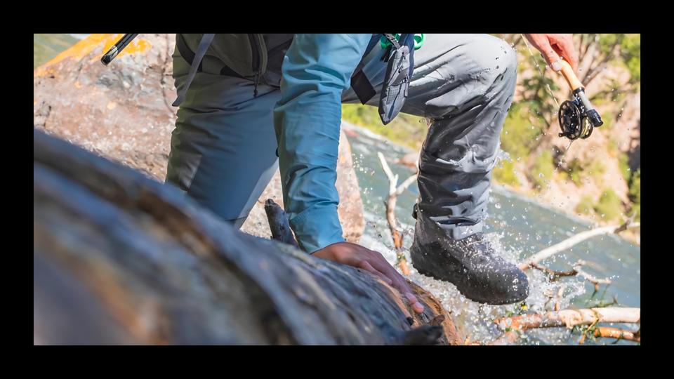 A man wearing the Orvis Pro LT Rubber Wading Boots