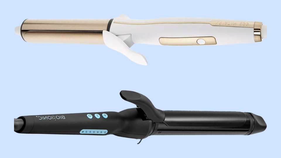 Two curling irons against light blue background