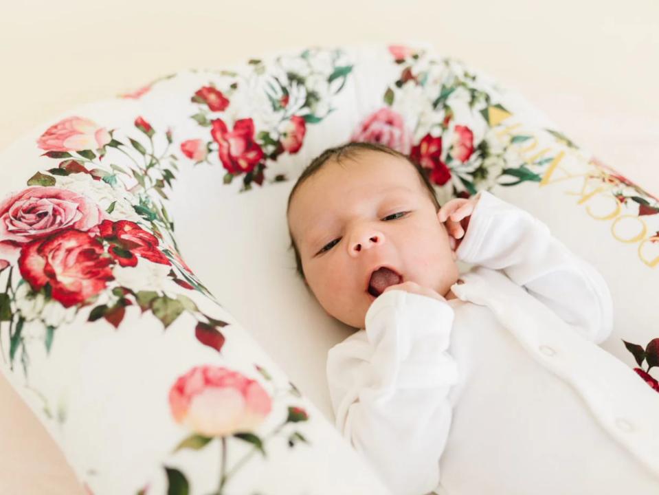 A newborn resting in a DockATot.