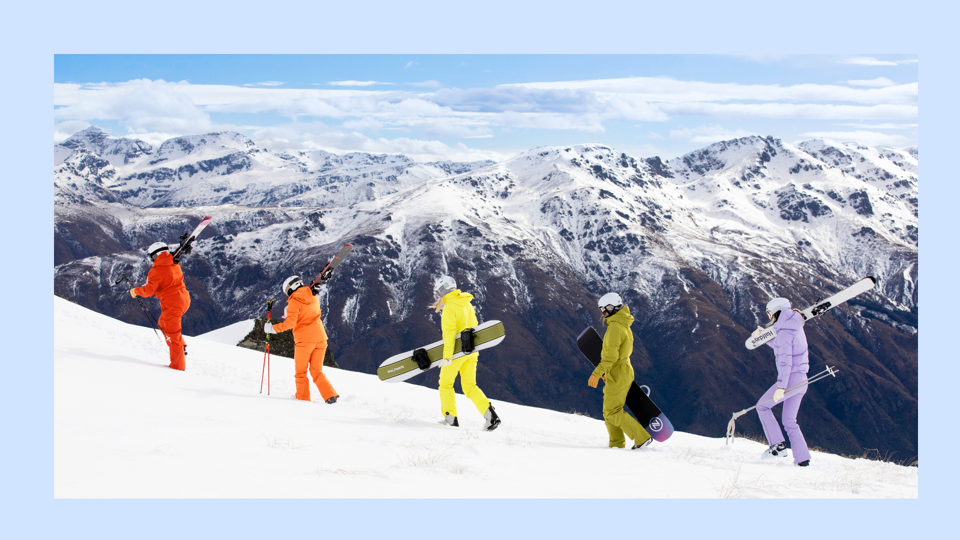 Five women wearing Halfdays skiwear on a snowy slope in the mountains