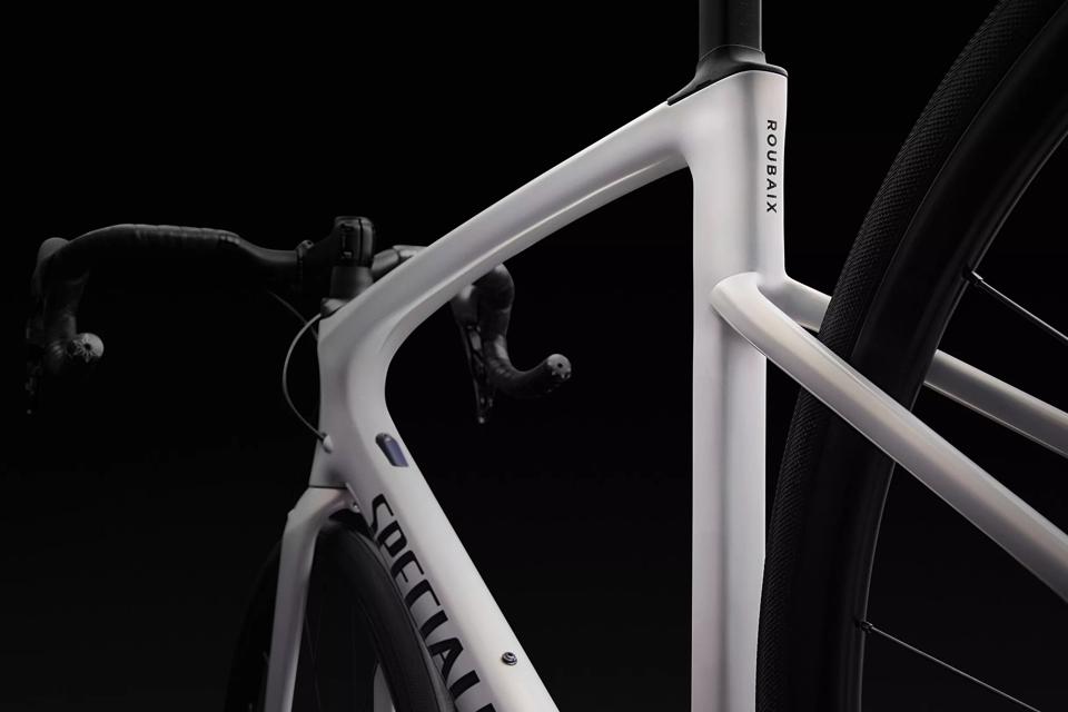 A Specialized Roubaix SL8 Comp in white on a black background