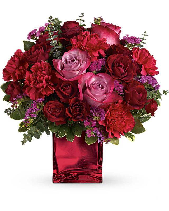 red lavender roses hot pink carnations fresh greens shiny red vase white background