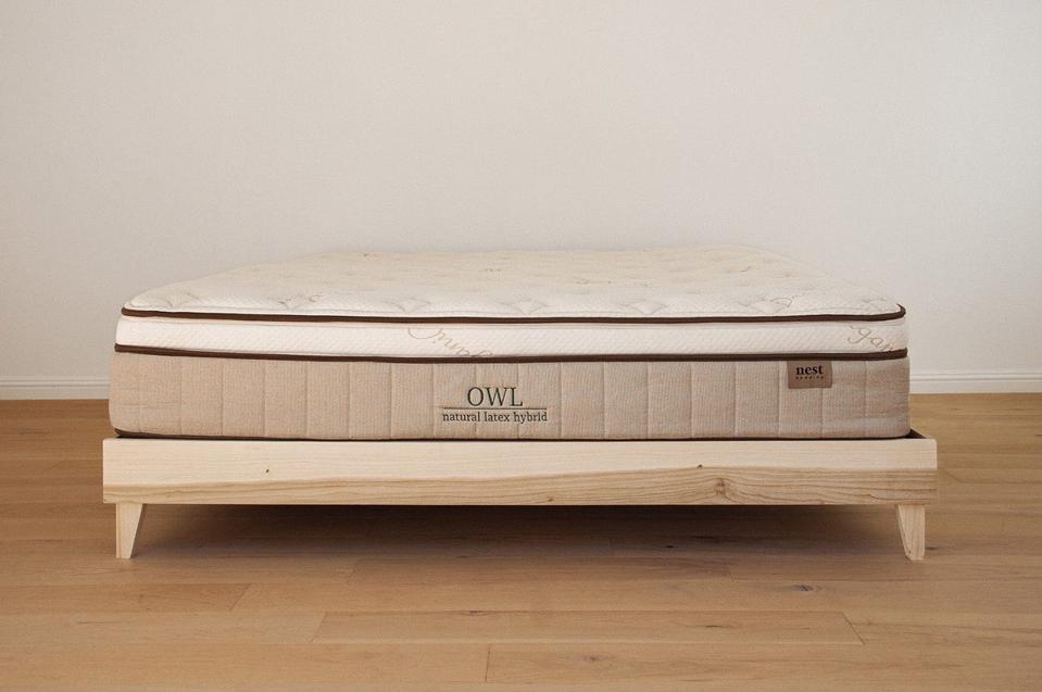 A mattress on top of the Woodland Platform from Nest Bedding on a wooden floor. 