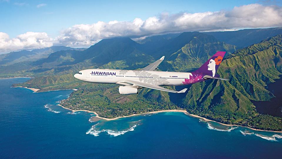 Hawaiian Air plane flying over the ocean