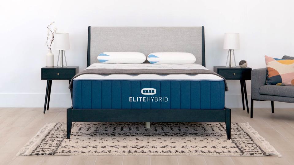 The Bear Elite Hybrid Mattress on a black bed frame. 