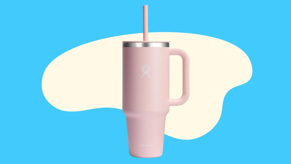 A pink Hydro Flask tumbler on a blue abstract background 