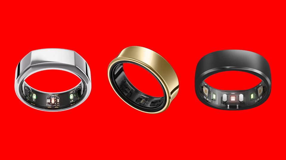 The Oura Ring Gen 3, Samsung Galaxy Ring and RingConn Smart Ring against a bright red background.