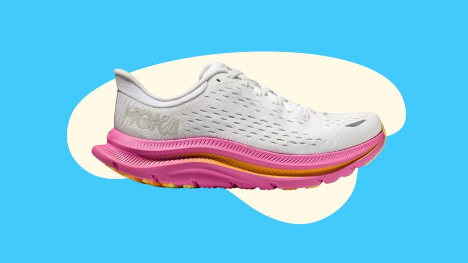 A white Hoka Kawana sneaker with a pink and orange sole on a blue abstract background