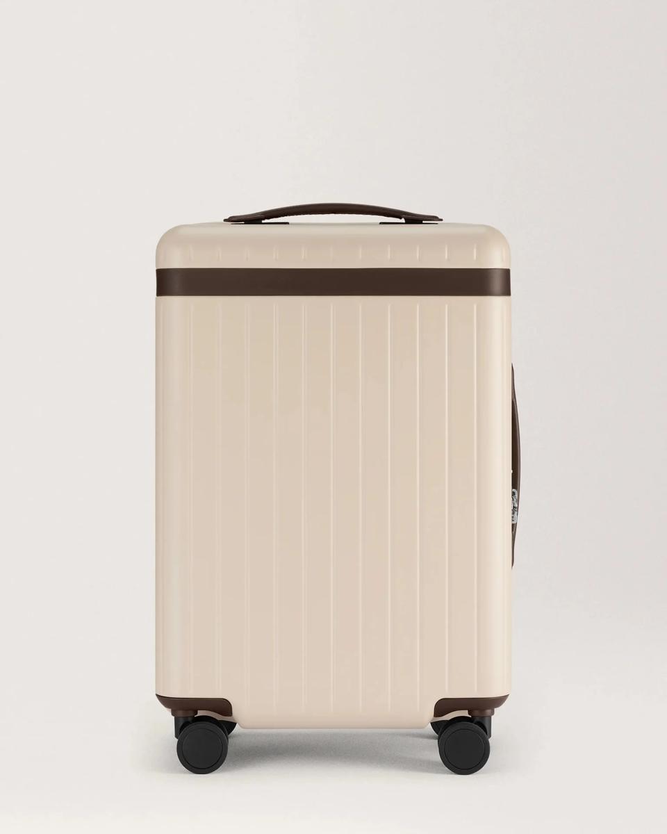 White suitcase with brown lining against a white background.