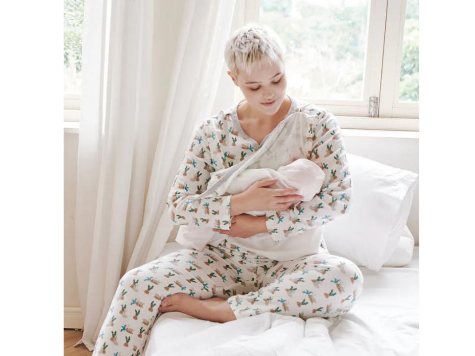 short-haired nursing mom wearing nest designs Bamboo Pima Long Sleeve Nursing PJs in nursery