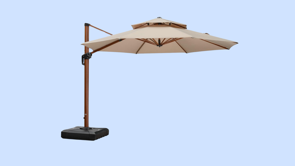 Tan cantilever patio umbrella on light blue background