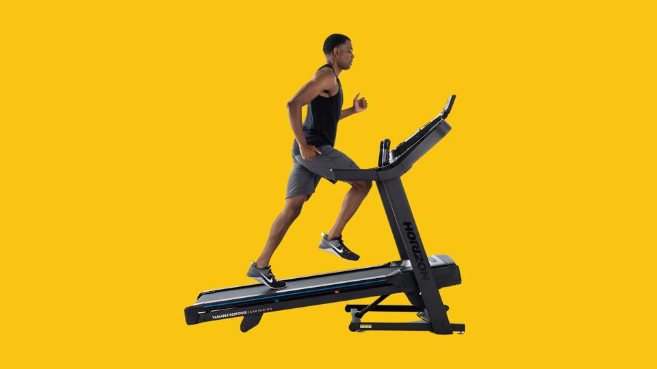 A man running on an inclined Horizon Fitness treadmill