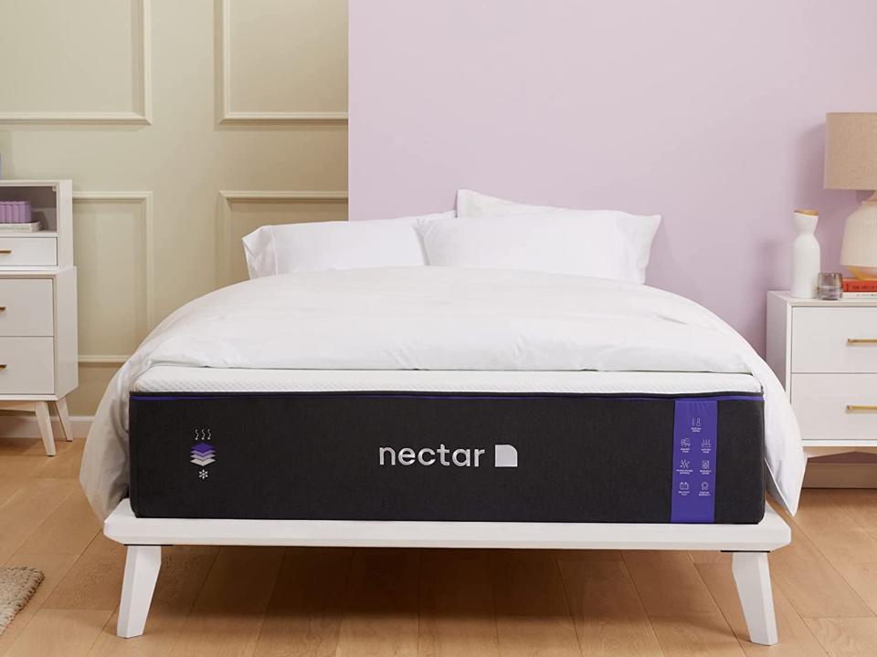 The Nectar Premier Mattress (Queen) in a brightly lit sparse bedroom w/ 2 white nightstands