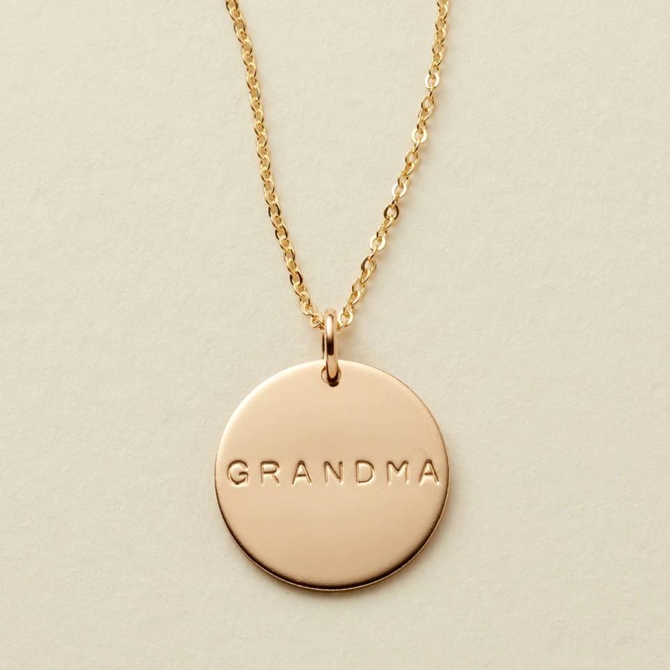 Gold Made By Mary Grandma Disc Necklace on a beige background