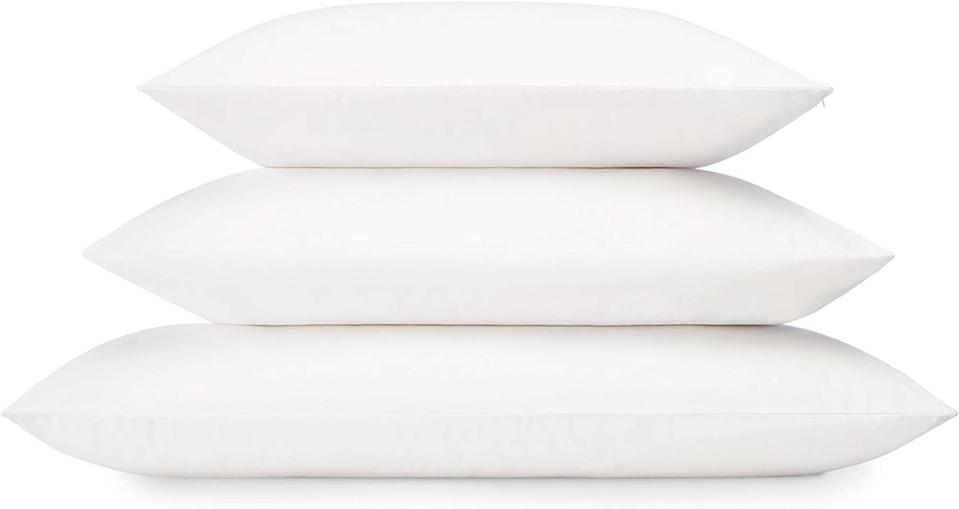 A stack of three pillows in three different sizes against a white background.