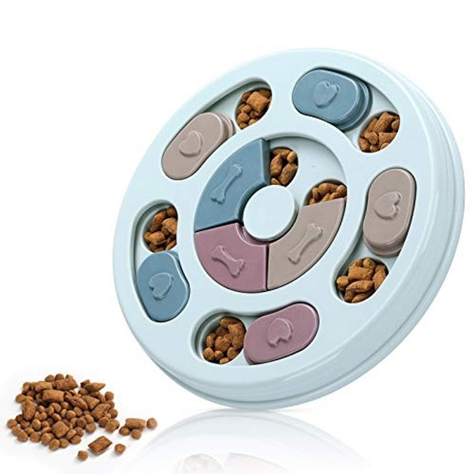 The Dr. Catch Dog Puzzle Feeder Toy in blue filled with dry kibble