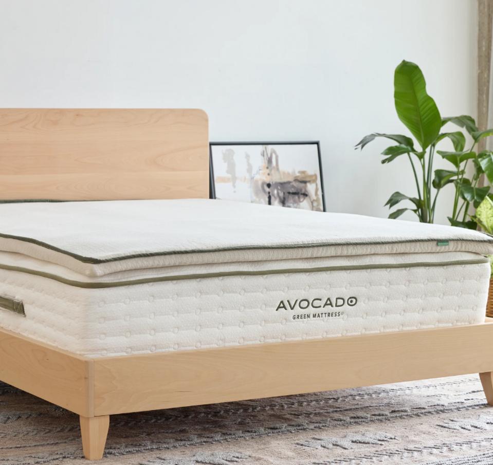 The Avocado Organic Latex Mattress Topper on an Avocado Mattress on a bed frame