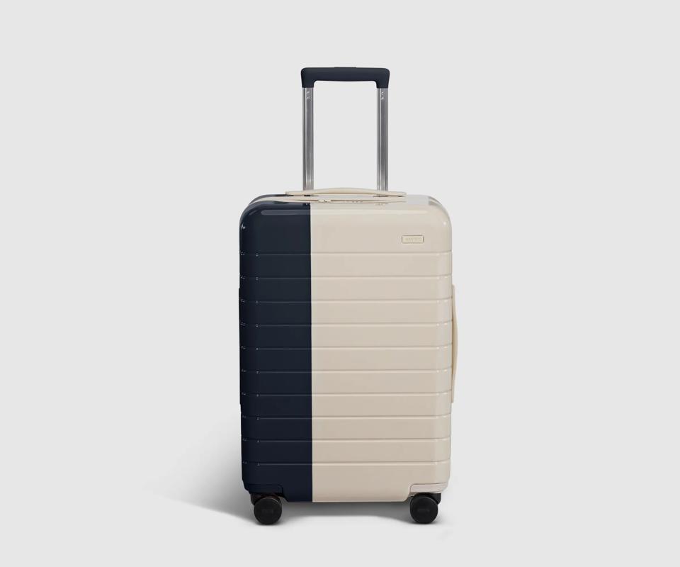 A white suitcase with a black stripe against a white background.