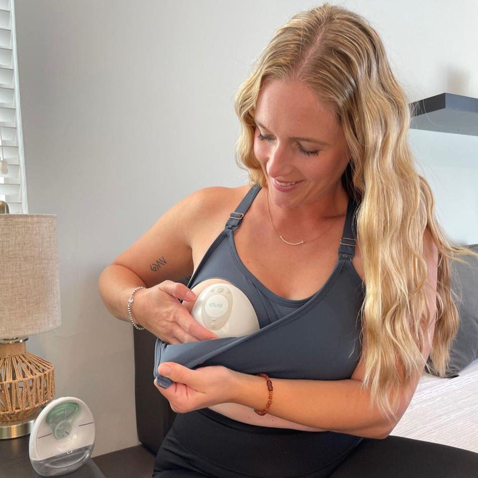 Woman wearing the Strappy Back 2.0 Nursing Sports Bra while using a breast pump