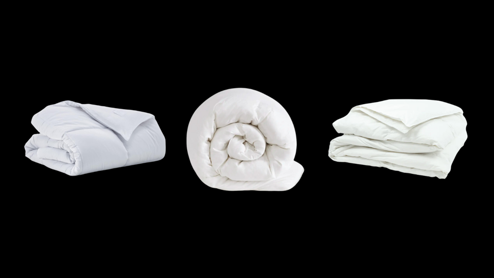 Three white down-alternative comforters on a black background