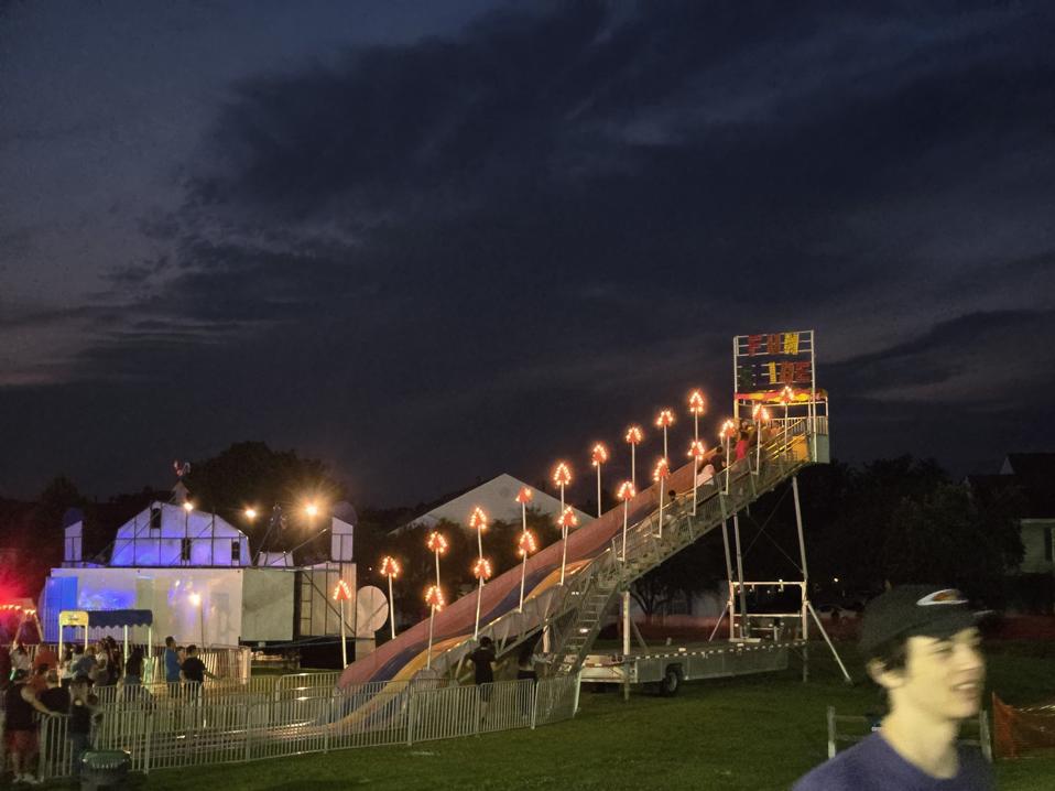 A carnival slide at night.