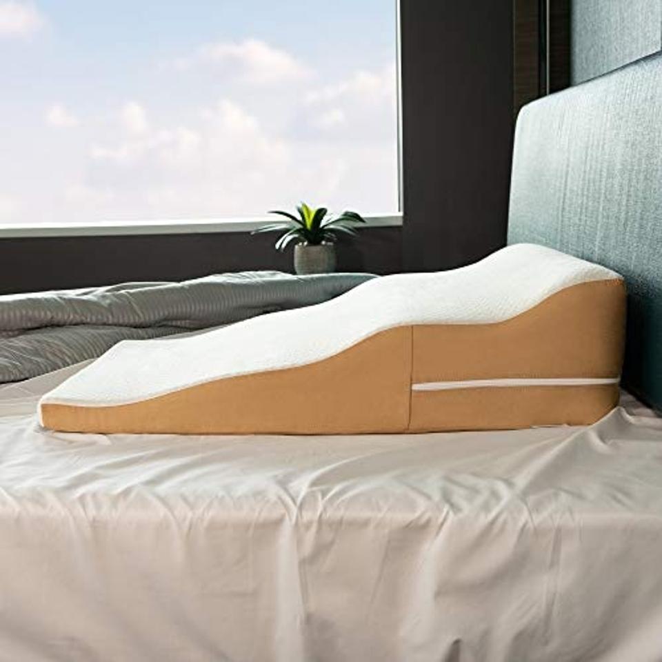 Avana Contoured Bed Wedge on bed in front of window.