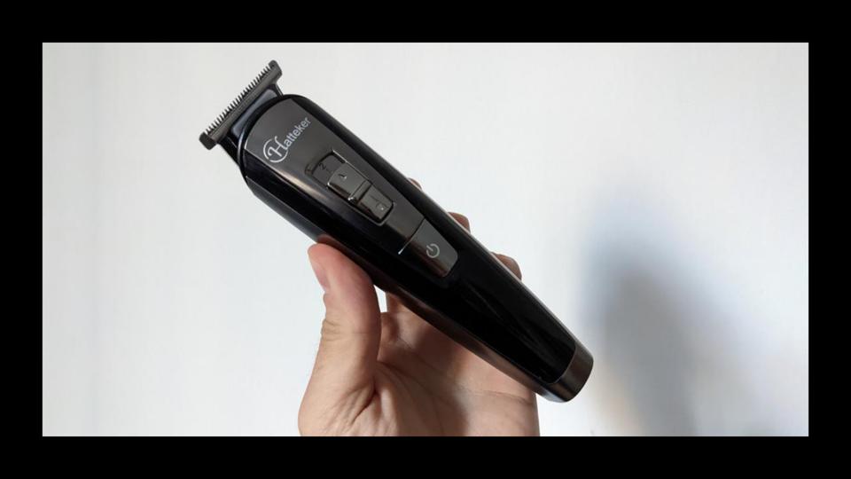 The Philips Norelco Multigroom 9000 held in front of a white background