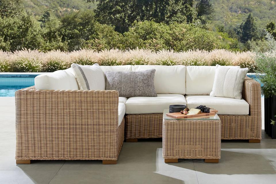 The Huntington Wicker 4-Piece Outdoor Sectional on a patio next to a pool