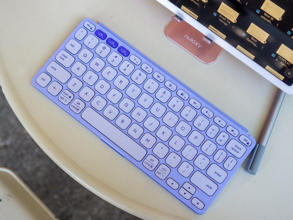 The Logitech Keys-To-Go 2 in Lilac on a white table.