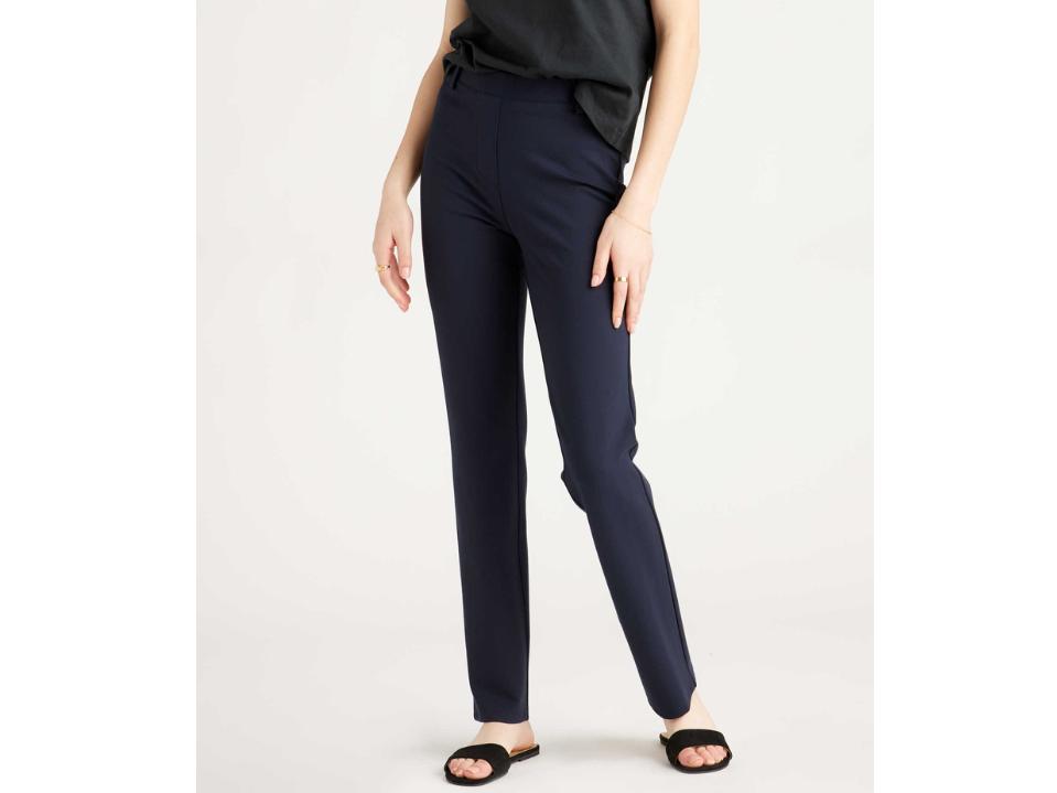 model wearing Quince navy Ultra-Stretch Ponte Straight Pants w/ gray top and black sandals