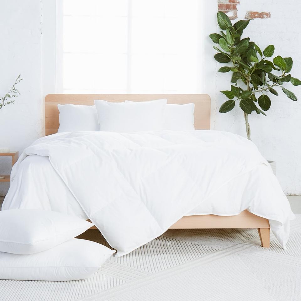 The Avocado Down Duvet Insert covering a mattress. 