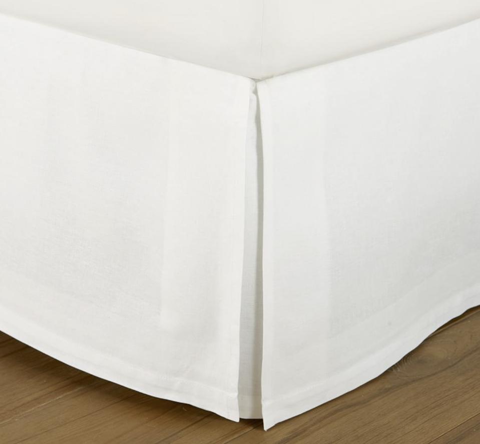 Pottery Barn Essential Linen Cotton Bed Skirt in white shown on the corner of a bed