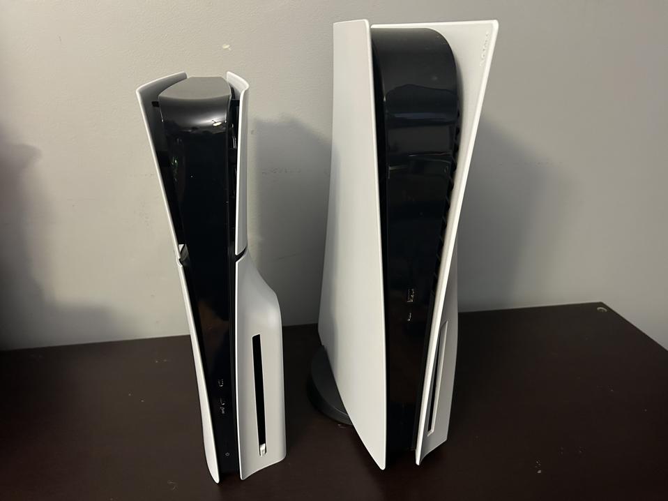 Two PlayStation 5s on a tabletop.