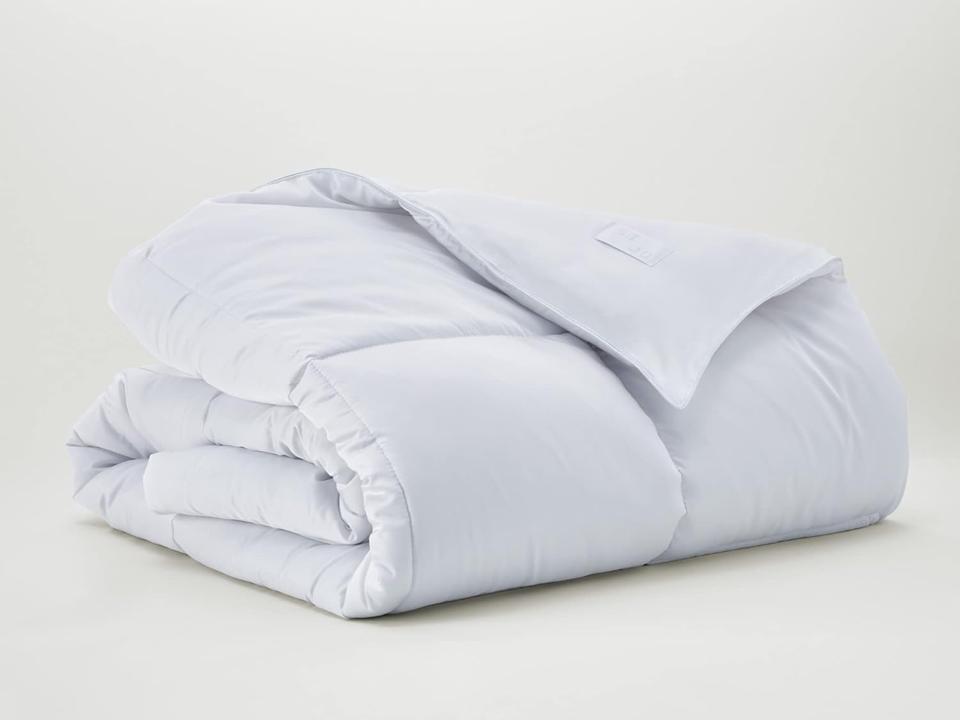 Sijo TempTune All Season Comforter folded and stacked against a cream background.