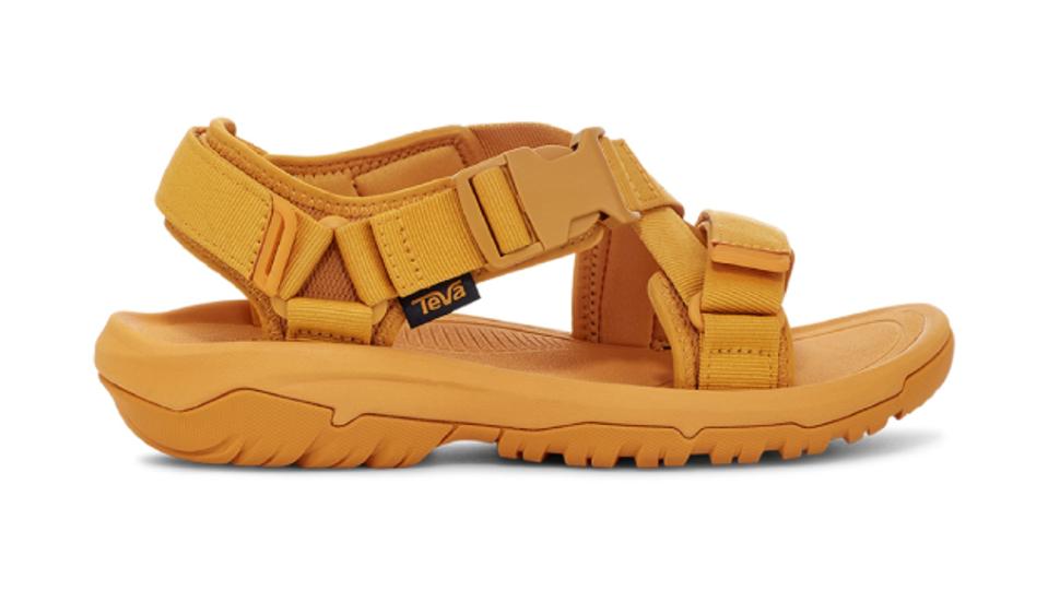 Product shot of a men's Teva Hurricane Verge Sandal in the golden orange colorway.