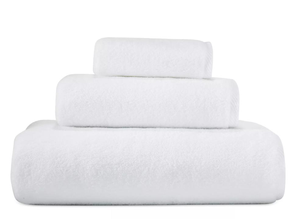 best bath towels: Matouk milagro white bath and smaller towels folded & stacked on white bg