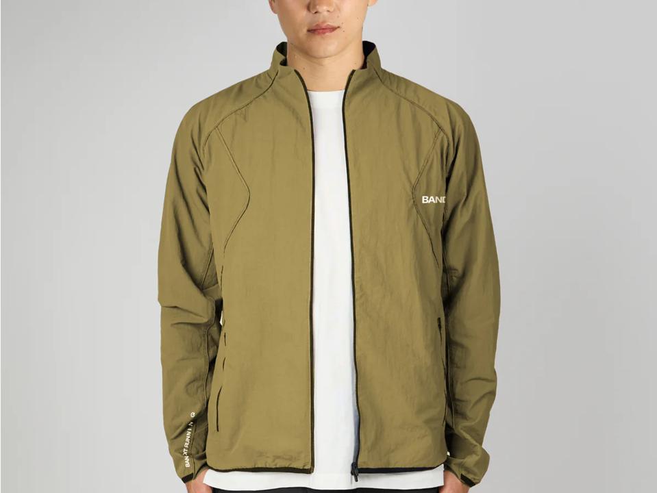 A man wearing the Bandit Japanese Ripstop Windbreaker in green