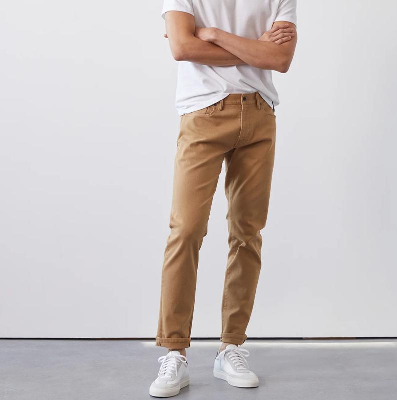 Todd Snyder Slim Fit 5-Pocket Chino on a model wearing white sneakers and a white t-shirt.